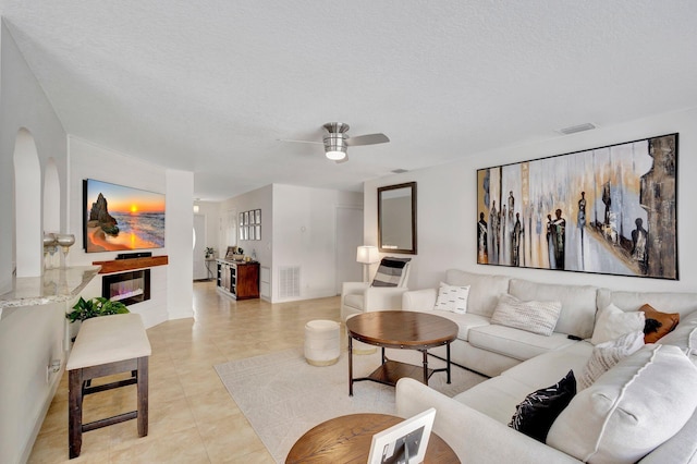 1275 Waterway Cove Dr, Wellington, FL 33414 - living area with arched walkways, a textured ceiling, visible vents, and a ceiling fan