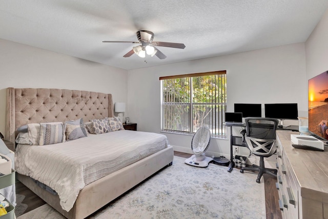1275 Waterway Cove Dr, Wellington, FL 33414 - bedroom featuring wood finished floors, a textured ceiling, a ceiling fan, and baseboards