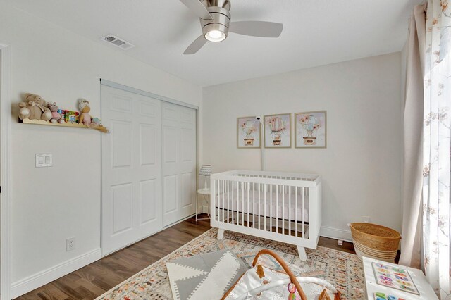 1275 Waterway Cove Dr, Wellington, FL 33414 - bedroom with a crib, wood finished floors, visible vents, and a closet
