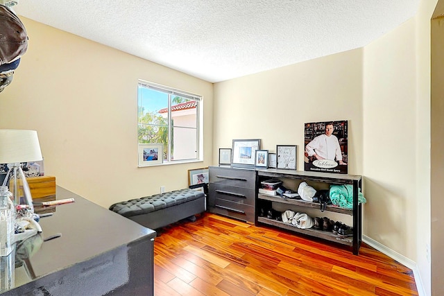 office space with light wood-style flooring and a textured ceiling