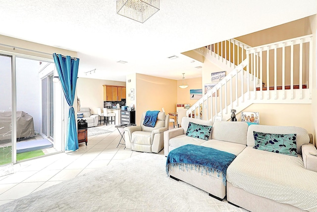 tiled living area with visible vents and stairs