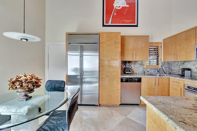 6130 Via Tierra, Boca Raton, FL 33433 - kitchen with a high ceiling, light stone counters, a sink, stainless steel appliances, and decorative backsplash