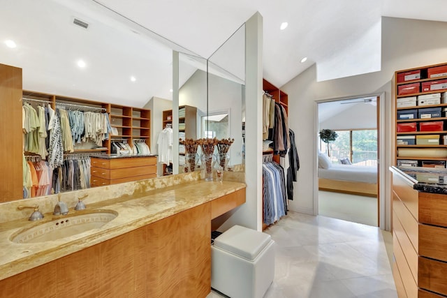 6130 Via Tierra, Boca Raton, FL 33433 - bathroom featuring a walk in closet, visible vents, vanity, recessed lighting, and vaulted ceiling