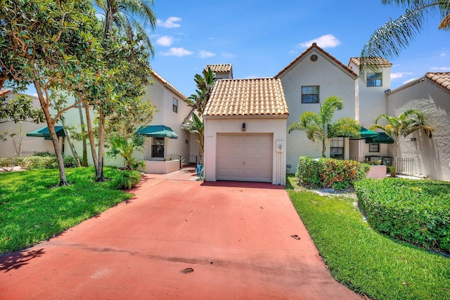 6130 Via Tierra, Boca Raton, FL 33433 - mediterranean / spanish-style home featuring a tiled roof, a front yard, a garage, concrete driveway, and stucco siding
