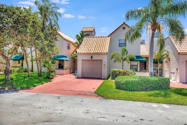 6130 Via Tierra, Boca Raton, FL 33433 - mediterranean / spanish home featuring an attached garage, stucco siding, a tiled roof, and concrete driveway