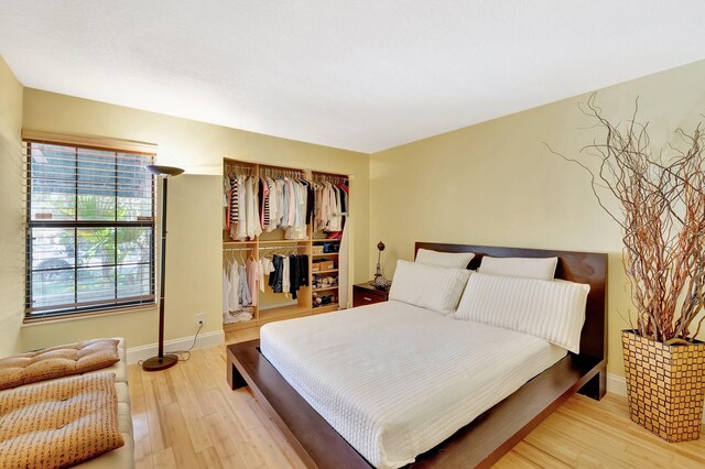 6130 Via Tierra, Boca Raton, FL 33433 - bedroom with a closet, baseboards, and light wood-type flooring