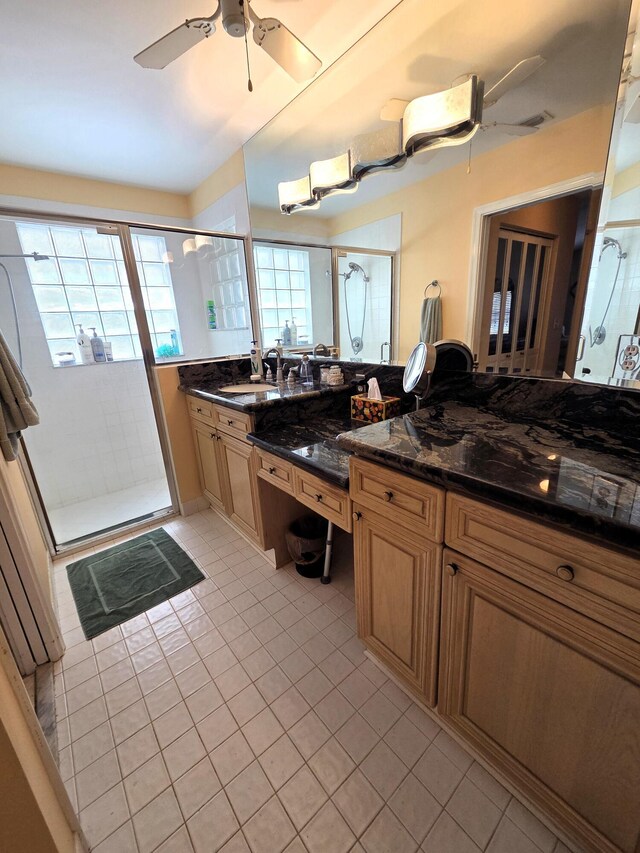 bathroom featuring tile patterned floors, vanity, a shower stall, and ceiling fan