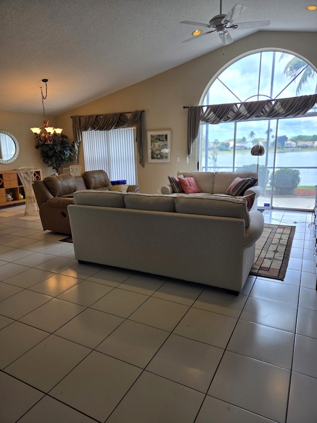 living room with vaulted ceiling, plenty of natural light, and light tile patterned floors