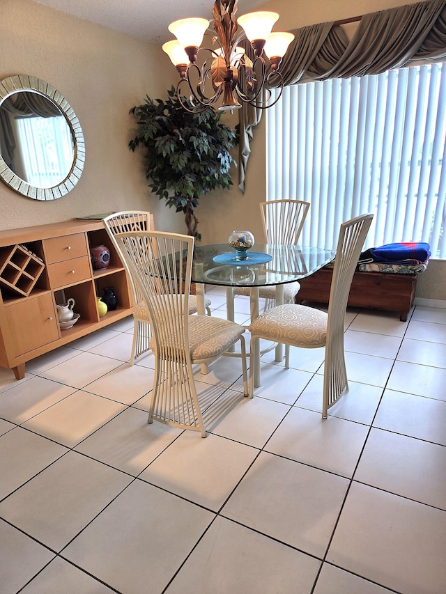 tiled dining area featuring a chandelier