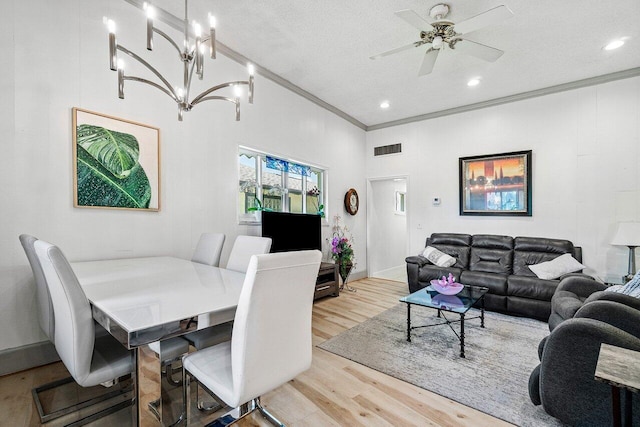 living room featuring crown molding, ceiling fan with notable chandelier, light wood-type flooring, visible vents, and recessed lighting