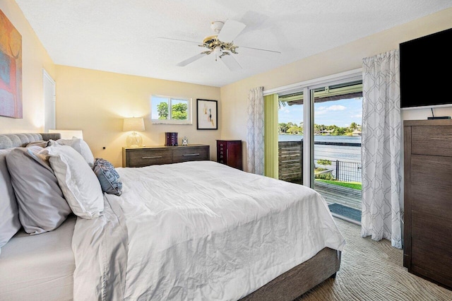 bedroom featuring carpet floors, a ceiling fan, and access to outside