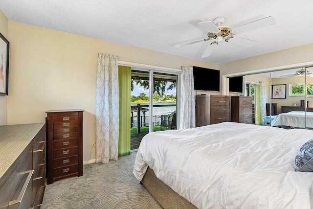 carpeted bedroom featuring a ceiling fan, baseboards, access to outside, and multiple windows