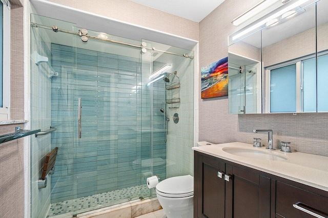full bath featuring vanity, toilet, and a stall shower