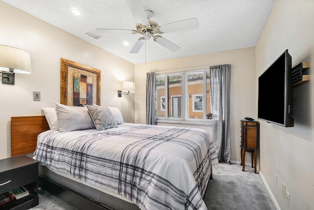 bedroom with a ceiling fan, a textured ceiling, baseboards, carpet flooring, and visible vents