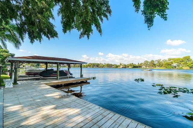 dock area with boat lift and a water view