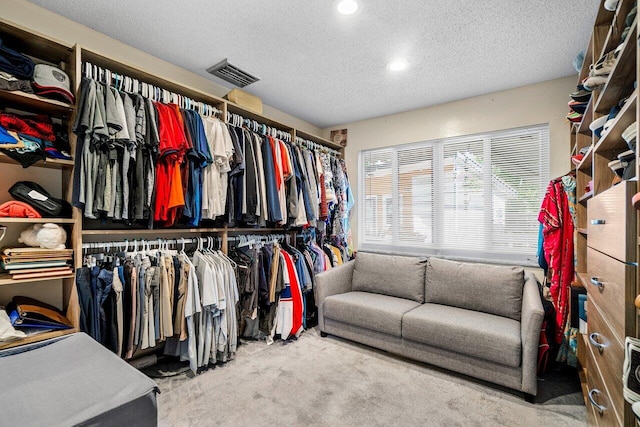 walk in closet featuring visible vents and carpet
