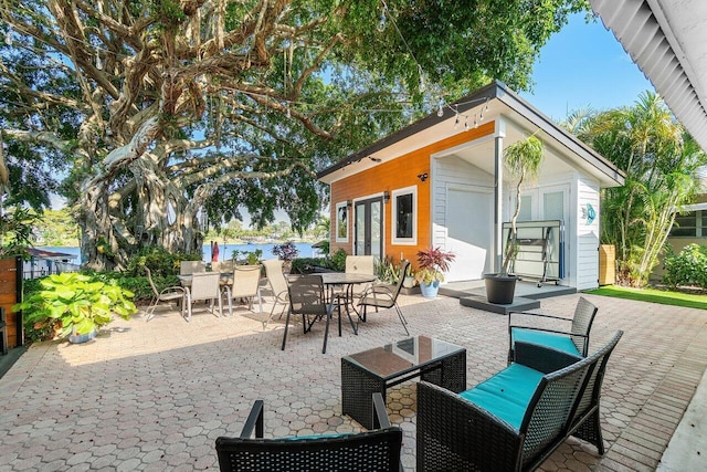 view of patio featuring an outdoor structure and outdoor dining space