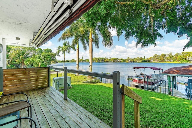 wooden terrace with a lawn and a water view