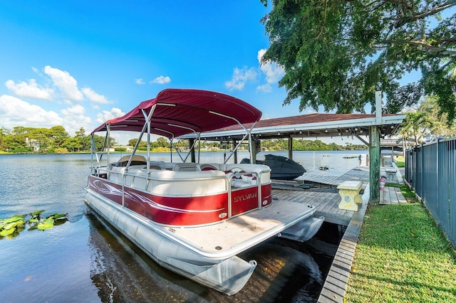 dock area with boat lift and a water view