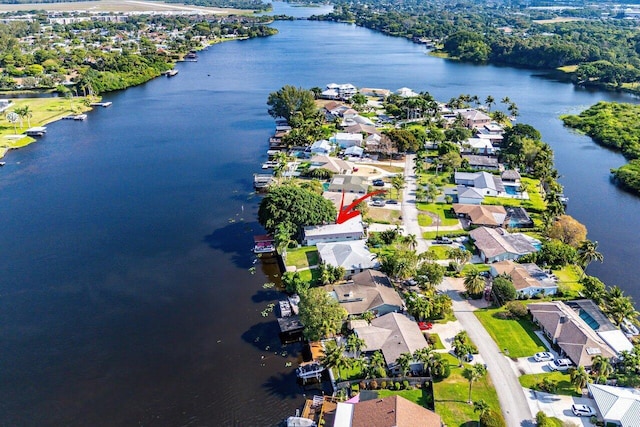 drone / aerial view with a residential view and a water view