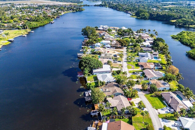 drone / aerial view with a water view and a residential view