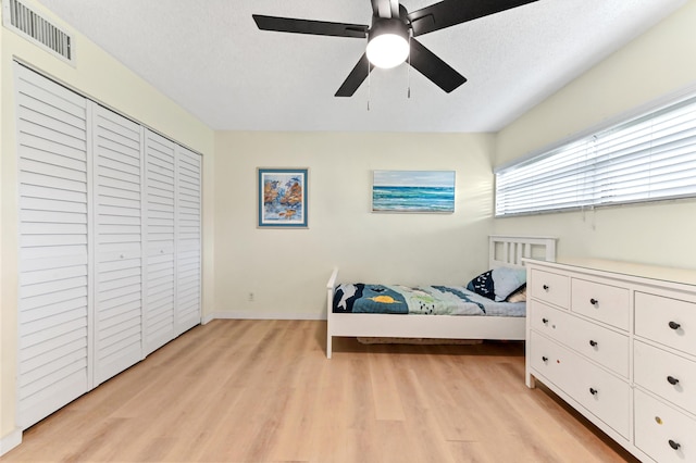 149 NW 70th St Unit 302B, Boca Raton, FL 33487 - bedroom featuring light wood-type flooring, a ceiling fan, baseboards, and a closet