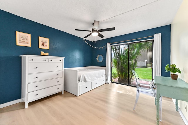 149 NW 70th St Unit 302B, Boca Raton, FL 33487 - bedroom with wood finished floors, a textured ceiling, a ceiling fan, and baseboards
