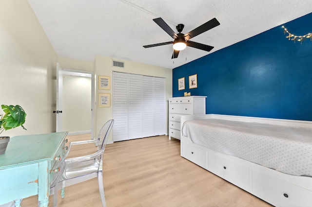 149 NW 70th St Unit 302B, Boca Raton, FL 33487 - bedroom featuring wood finished floors, a closet, ceiling fan, and a textured ceiling