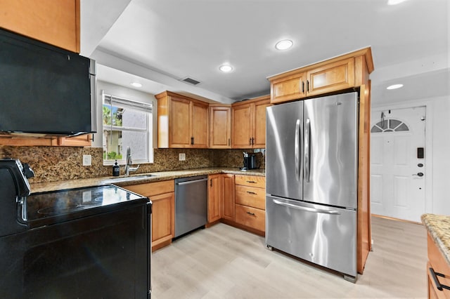 149 NW 70th St Unit 302B, Boca Raton, FL 33487 - kitchen with appliances with stainless steel finishes, a sink, light wood-style flooring, decorative backsplash, and recessed lighting