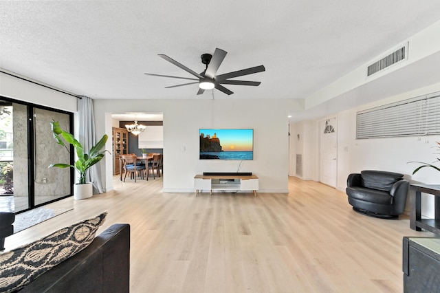 149 NW 70th St Unit 302B, Boca Raton, FL 33487 - living room featuring wood finished floors, a chandelier, a ceiling fan, and baseboards