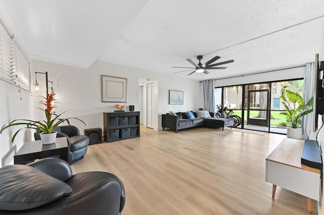 149 NW 70th St Unit 302B, Boca Raton, FL 33487 - living area featuring a ceiling fan, light wood-style flooring, and a textured ceiling