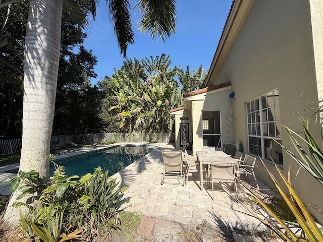 view of pool featuring a patio area, a fenced backyard, and outdoor dining area