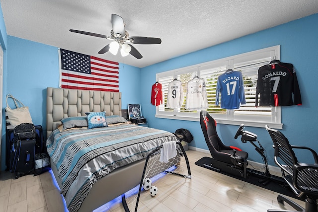 bedroom with baseboards, a textured ceiling, and ceiling fan