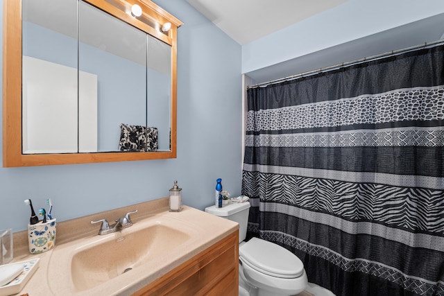bathroom with a shower with shower curtain, toilet, and vanity
