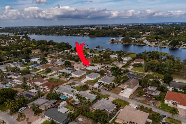 birds eye view of property with a residential view and a water view