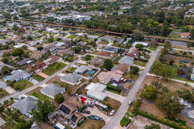 drone / aerial view with a residential view and a water view