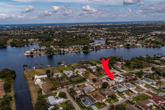 drone / aerial view featuring a water view and a residential view