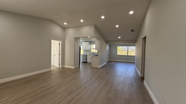 11771 NW 37th St, Sunrise, FL 33323 - unfurnished living room with dark wood-style flooring, visible vents, baseboards, recessed lighting, and high vaulted ceiling