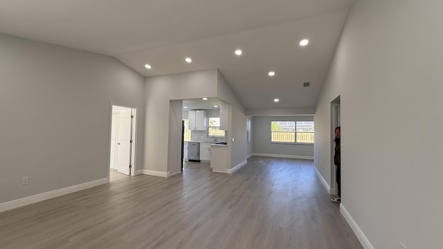 11771 NW 37th St, Sunrise, FL 33323 - unfurnished living room with high vaulted ceiling, wood finished floors, baseboards, visible vents, and recessed lighting