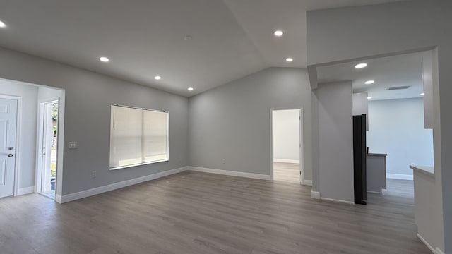 11771 NW 37th St, Sunrise, FL 33323 - unfurnished living room featuring recessed lighting, wood finished floors, lofted ceiling, and baseboards