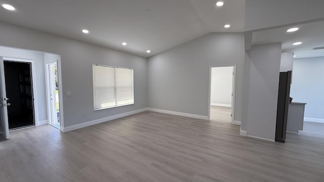 11771 NW 37th St, Sunrise, FL 33323 - unfurnished living room featuring baseboards, lofted ceiling, wood finished floors, and recessed lighting