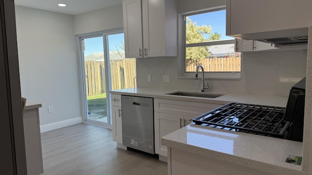 11771 NW 37th St, Sunrise, FL 33323 - kitchen featuring a wealth of natural light, stainless steel dishwasher, a sink, and light wood-style floors