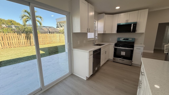 11771 NW 37th St, Sunrise, FL 33323 - kitchen with light wood finished floors, plenty of natural light, appliances with stainless steel finishes, and a sink