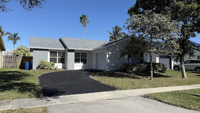 11771 NW 37th St, Sunrise, FL 33323 - single story home with an attached garage, brick siding, driveway, and a front lawn