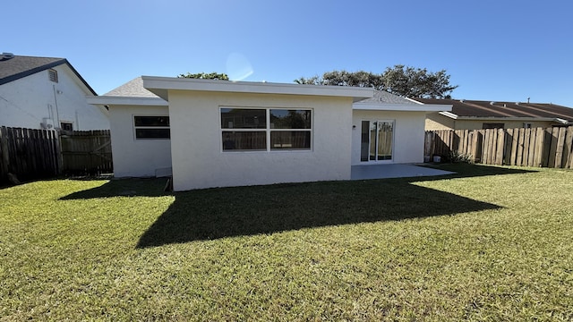11771 NW 37th St, Sunrise, FL 33323 - back of house featuring stucco siding, a yard, and a fenced backyard