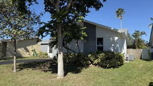 11771 NW 37th St, Sunrise, FL 33323 - view of home's exterior featuring fence and a lawn