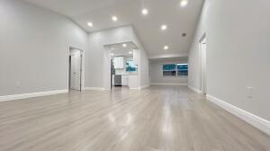 11771 NW 37th St, Sunrise, FL 33323 - unfurnished living room featuring baseboards, light wood-type flooring, and recessed lighting