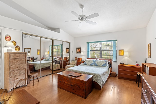 7414 Rosewood Cir, Boca Raton, FL 33487 - bedroom with light wood finished floors, vaulted ceiling, a closet, and a ceiling fan
