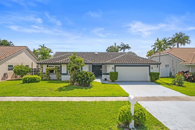 7414 Rosewood Cir, Boca Raton, FL 33487 - single story home with an attached garage, a tiled roof, fence, and stucco siding