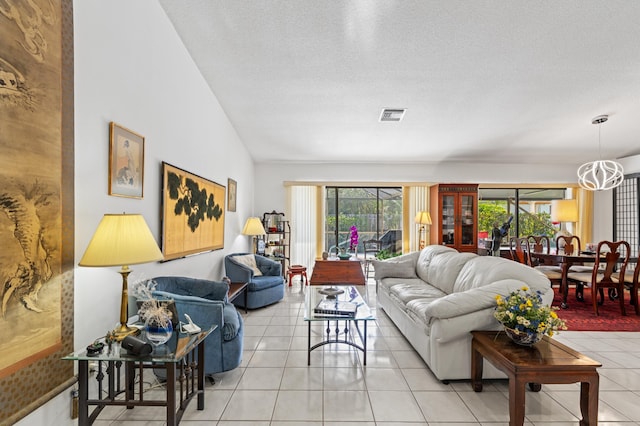 7414 Rosewood Cir, Boca Raton, FL 33487 - living room featuring a textured ceiling, light tile patterned flooring, a chandelier, lofted ceiling, and visible vents